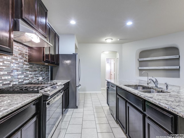 542 Snowy Egret, San Antonio, TX 78253 - kitchen with arched walkways, a sink, stainless steel gas range, dishwasher, and under cabinet range hood