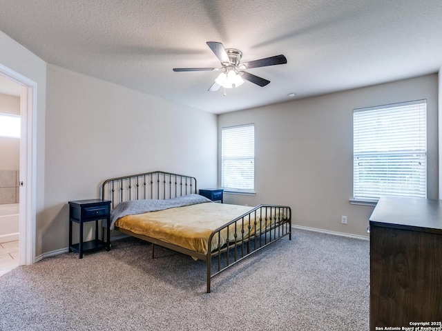 542 Snowy Egret, San Antonio, TX 78253 - carpeted bedroom with a textured ceiling, ensuite bath, baseboards, and ceiling fan