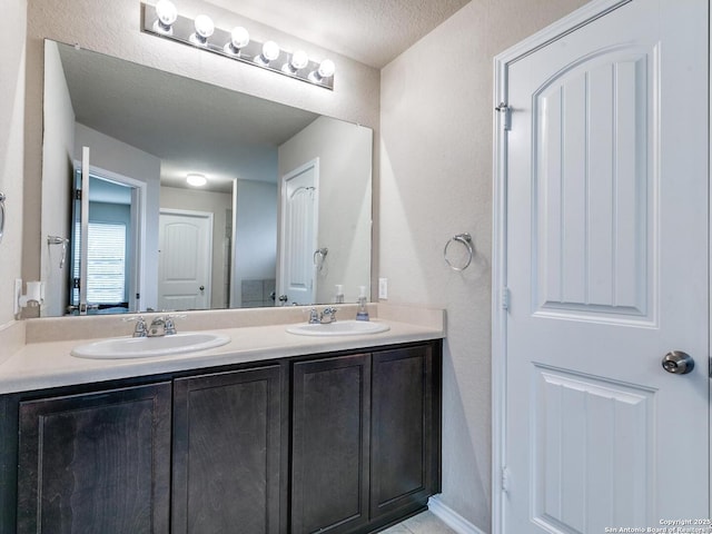 542 Snowy Egret, San Antonio, TX 78253 - bathroom with a sink, double vanity, and a textured ceiling