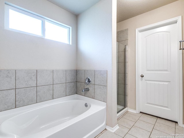 542 Snowy Egret, San Antonio, TX 78253 - bathroom featuring a bath, tile patterned floors, and a shower stall
