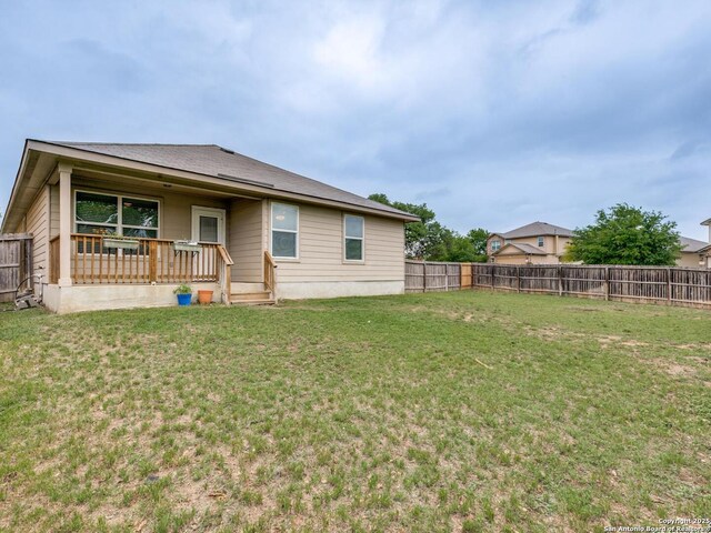 542 Snowy Egret, San Antonio, TX 78253 - back of property featuring a lawn, a fenced backyard, and covered porch