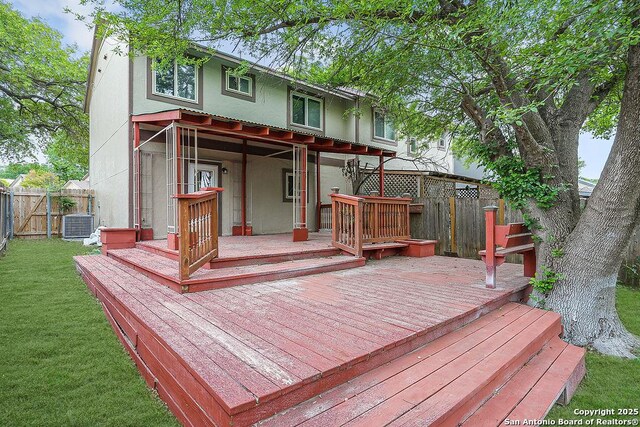 back of house with a wooden deck, a fenced backyard, a yard, and central air condition unit