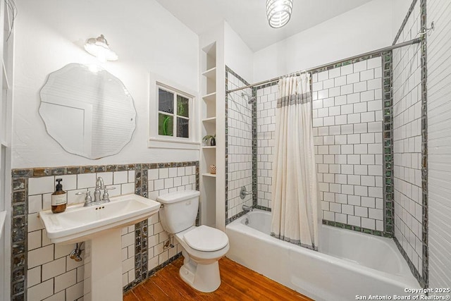 356 Kessler, New Braunfels, TX 78130 - full bath featuring toilet, tile walls, wainscoting, shower / tub combo, and wood finished floors