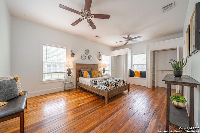 356 Kessler, New Braunfels, TX 78130 - bedroom featuring wood-type flooring, multiple windows, and visible vents
