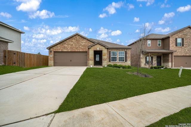 single story home featuring fence, a front lawn, an attached garage, driveway, and stone siding