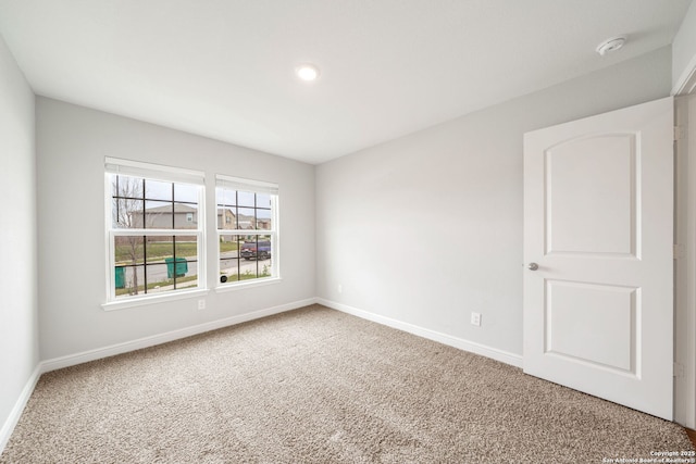 empty room with baseboards, carpet flooring, and recessed lighting