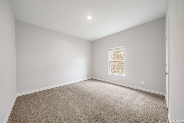 carpeted empty room featuring recessed lighting and baseboards