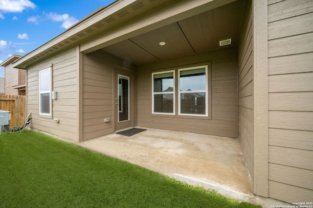 back of property featuring a yard, a patio area, and fence