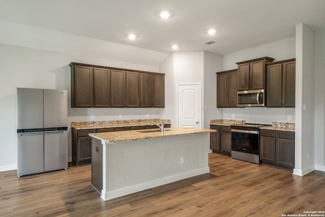 kitchen with recessed lighting, dark brown cabinets, wood finished floors, visible vents, and appliances with stainless steel finishes