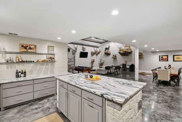 148 Lakecreek, New Braunfels, TX 78130 - kitchen featuring recessed lighting, visible vents, gray cabinets, a kitchen island, and concrete floors