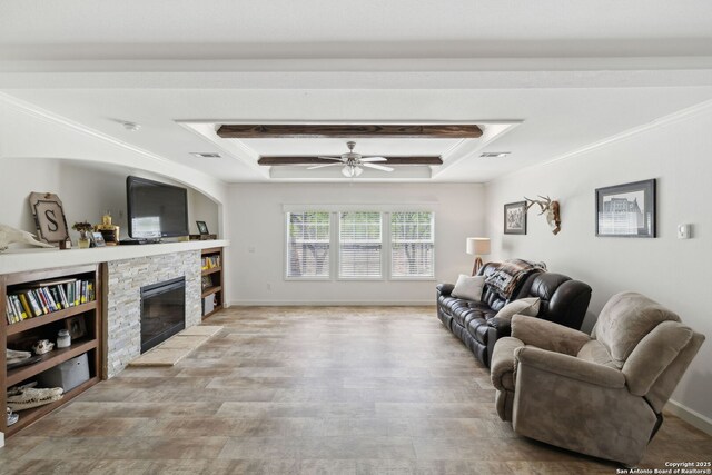 148 Lakecreek, New Braunfels, TX 78130 - living room with a raised ceiling, a stone fireplace, a ceiling fan, and light wood-style flooring