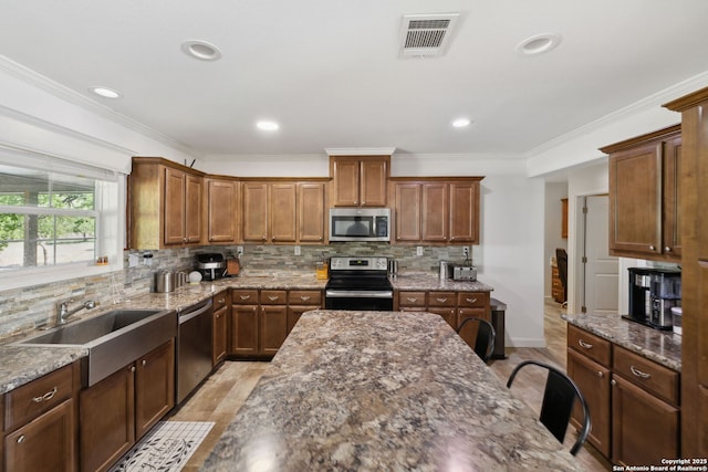 148 Lakecreek, New Braunfels, TX 78130 - kitchen featuring stainless steel appliances, a sink, dark stone countertops, visible vents, and decorative backsplash