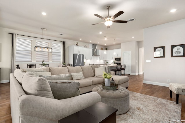 11206 Coppola, San Antonio, TX 78254 - living room featuring recessed lighting, baseboards, wood finished floors, and ceiling fan with notable chandelier