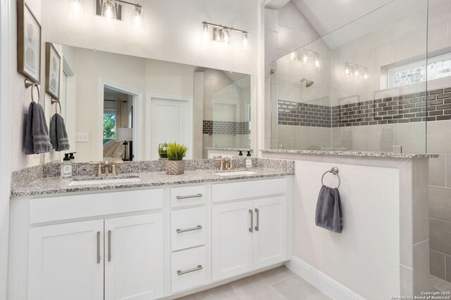 11206 Coppola, San Antonio, TX 78254 - bathroom with a tile shower, a healthy amount of sunlight, a sink, and double vanity
