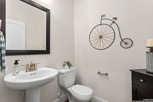 11206 Coppola, San Antonio, TX 78254 - half bathroom featuring toilet, a sink, and baseboards