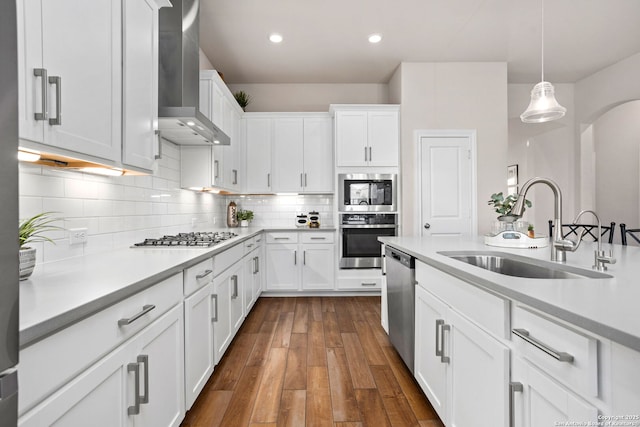11206 Coppola, San Antonio, TX 78254 - kitchen featuring wall chimney exhaust hood, white cabinets, a sink, light countertops, and appliances with stainless steel finishes