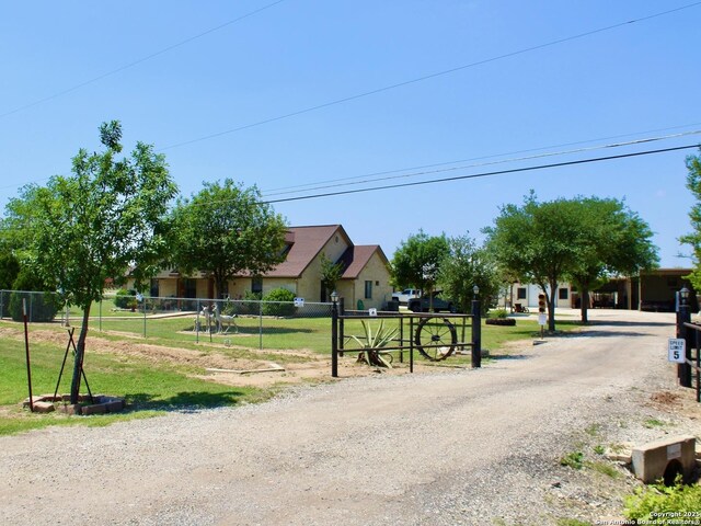 12365 Rudolph Rd, Atascosa, TX 78002 - view of road with gravel driveway and a gated entry