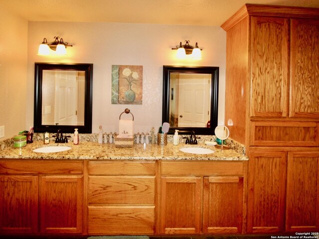 12365 Rudolph Rd, Atascosa, TX 78002 - full bathroom featuring a sink and double vanity
