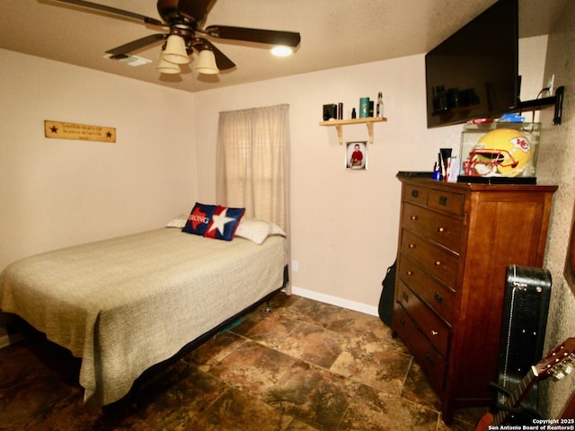 12365 Rudolph Rd, Atascosa, TX 78002 - bedroom featuring baseboards, stone finish floor, and visible vents