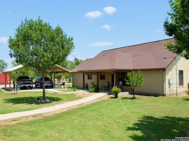 12365 Rudolph Rd, Atascosa, TX 78002 - ranch-style house with a carport, driveway, and a front lawn