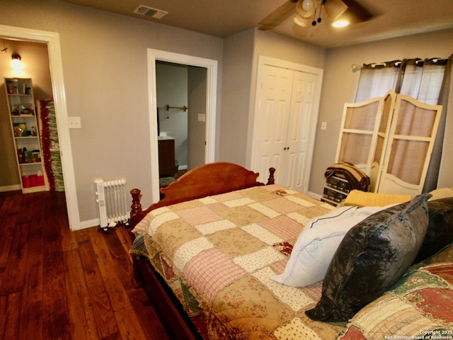 12365 Rudolph Rd, Atascosa, TX 78002 - bedroom with radiator heating unit, wood finished floors, visible vents, a closet, and baseboards
