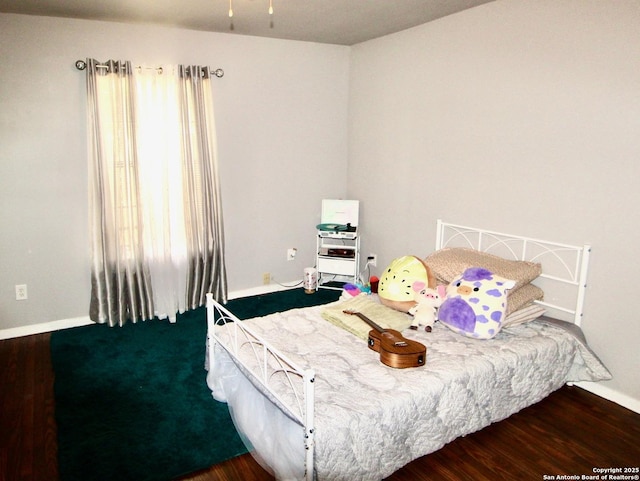 12365 Rudolph Rd, Atascosa, TX 78002 - bedroom featuring baseboards and wood finished floors