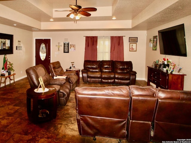 12365 Rudolph Rd, Atascosa, TX 78002 - living room featuring baseboards, a ceiling fan, and a tray ceiling