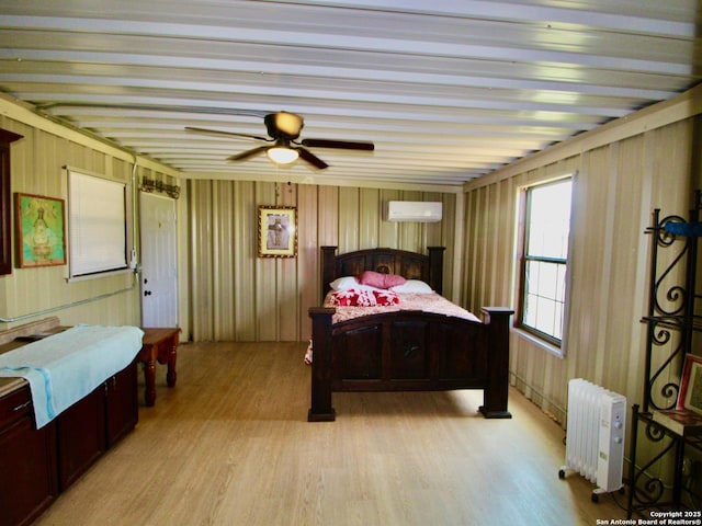 12365 Rudolph Rd, Atascosa, TX 78002 - bedroom with radiator, light wood finished floors, and a wall unit AC