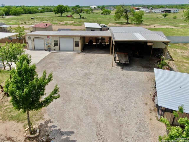 12365 Rudolph Rd, Atascosa, TX 78002 - view of front of home with fence, a carport, dirt driveway, and a garage