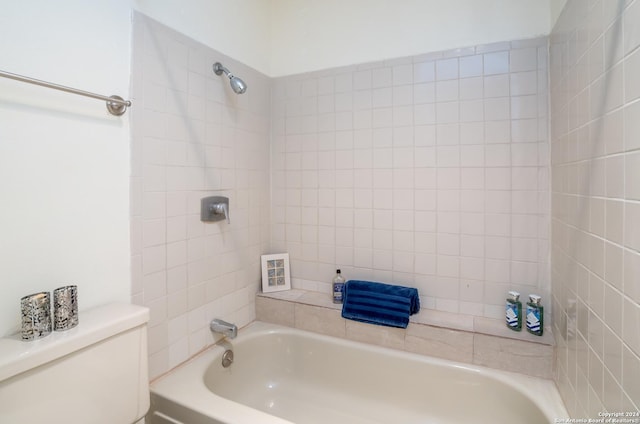 full bathroom featuring bathing tub / shower combination and toilet