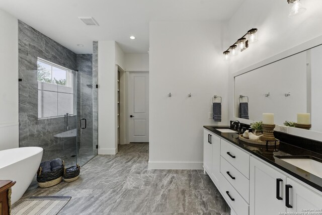 full bathroom featuring a soaking tub, a sink, double vanity, a stall shower, and marble finish floor