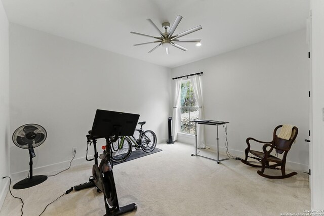 exercise area with baseboards, carpet, and ceiling fan