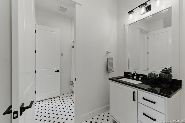 bathroom featuring baseboards and vanity