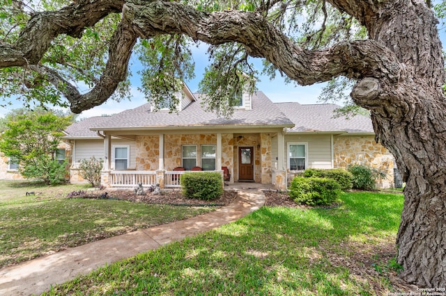 108 County Road 4325, Hondo, TX 78861 - ranch-style house with stone siding, a front yard, and covered porch