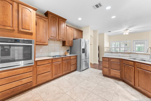 108 County Road 4325, Hondo, TX 78861 - kitchen featuring visible vents, a sink, decorative backsplash, appliances with stainless steel finishes, and ceiling fan