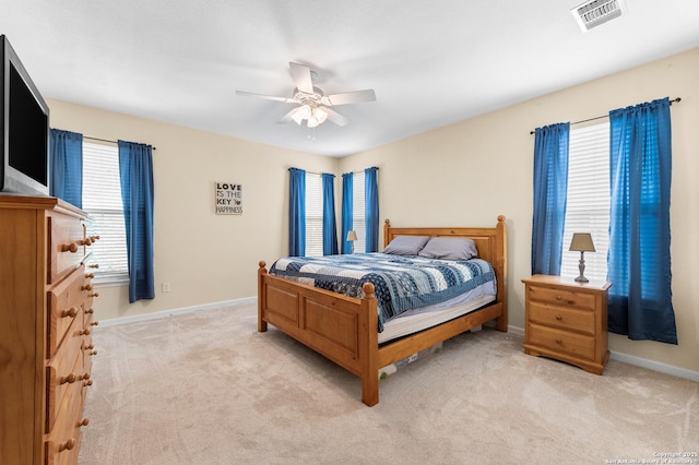 108 County Road 4325, Hondo, TX 78861 - bedroom featuring ceiling fan, light carpet, visible vents, and baseboards