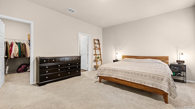 bedroom featuring carpet flooring, baseboards, visible vents, a spacious closet, and a closet