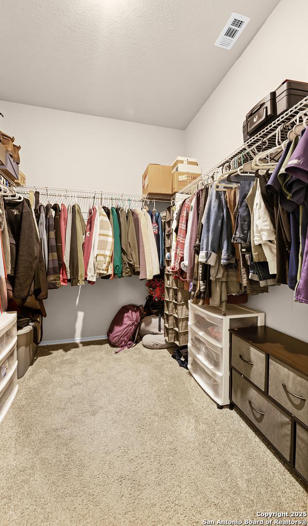 spacious closet featuring carpet floors and visible vents