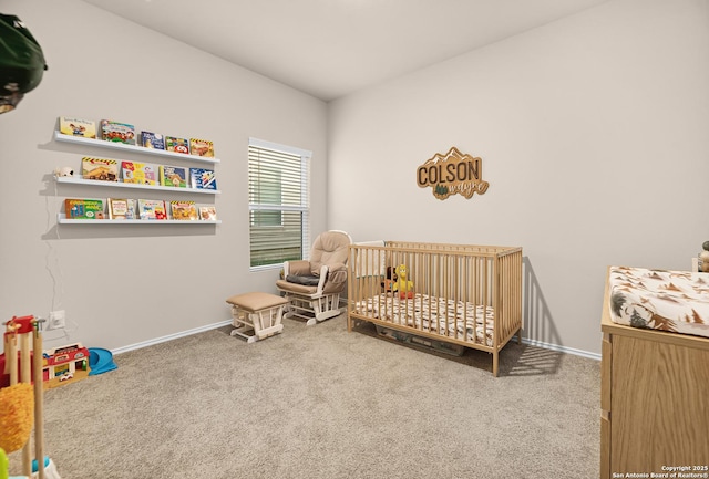 bedroom featuring baseboards, carpet floors, and a nursery area