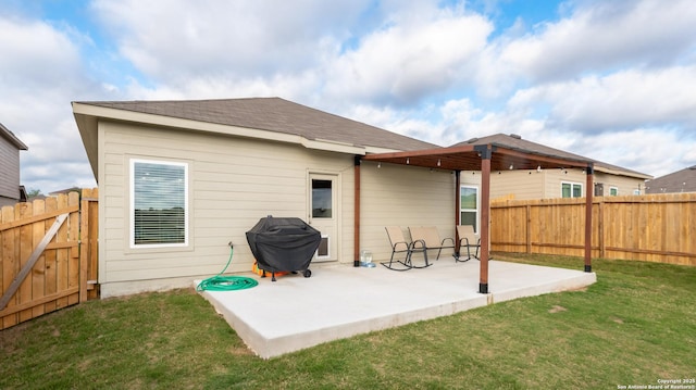rear view of house with a patio area, a lawn, and a fenced backyard
