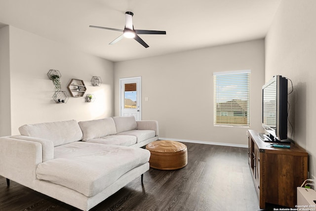 living room with plenty of natural light, dark wood-style floors, and ceiling fan