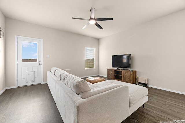 living area featuring ceiling fan, baseboards, and dark wood-style flooring