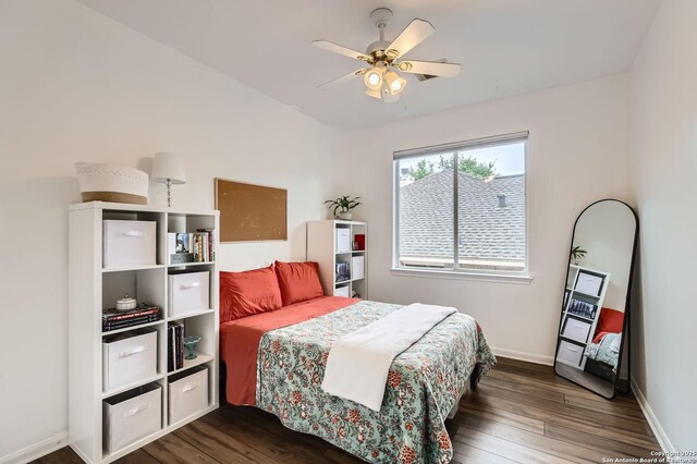 bedroom with ceiling fan, baseboards, and dark wood-style flooring