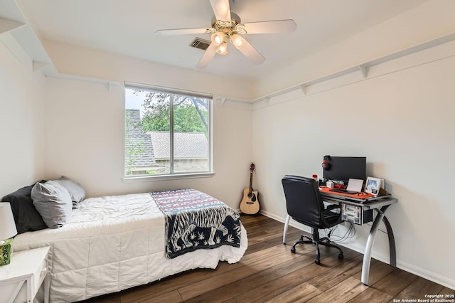 bedroom featuring baseboards, a ceiling fan, wood finished floors, and visible vents