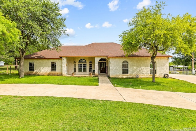 12037 Poinciana, San Antonio, TX 78245 - view of front of home with a front lawn, stone siding, covered porch, fence, and roof with shingles