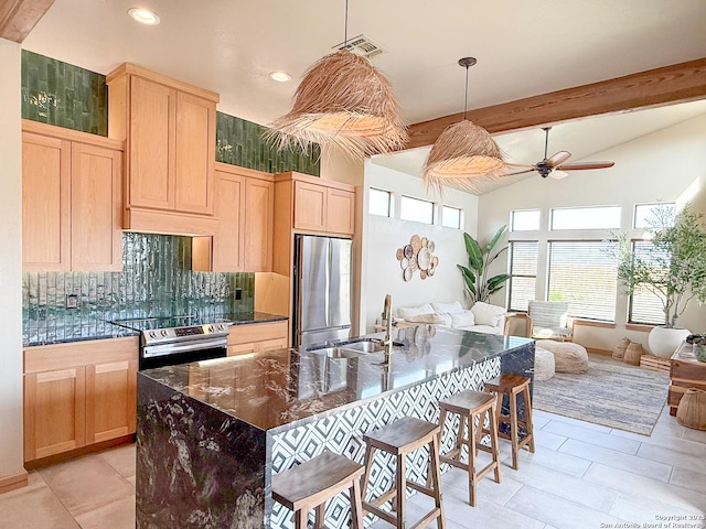 kitchen with visible vents, stainless steel appliances, light brown cabinetry, and a sink