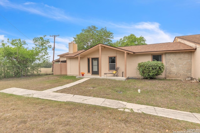 1051 Country Clb Unit 20, Seguin, TX 78155 - view of front of property with a front lawn, roof with shingles, a chimney, and fence