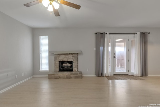 1051 Country Clb Unit 20, Seguin, TX 78155 - unfurnished living room featuring baseboards, a ceiling fan, wood finished floors, and a fireplace