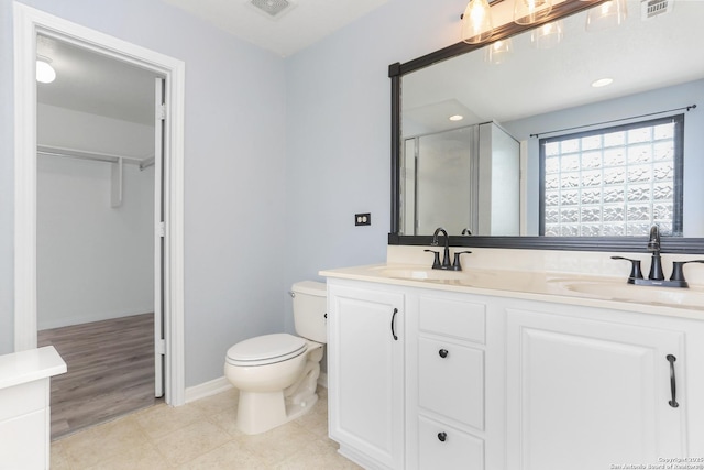 full bath with a shower stall, visible vents, and a sink