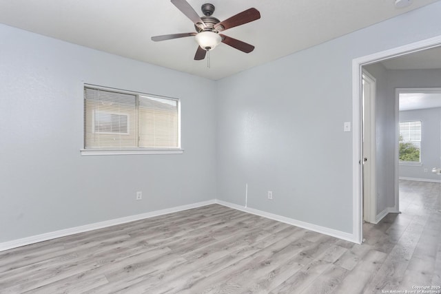 spare room with light wood-style flooring, baseboards, and ceiling fan